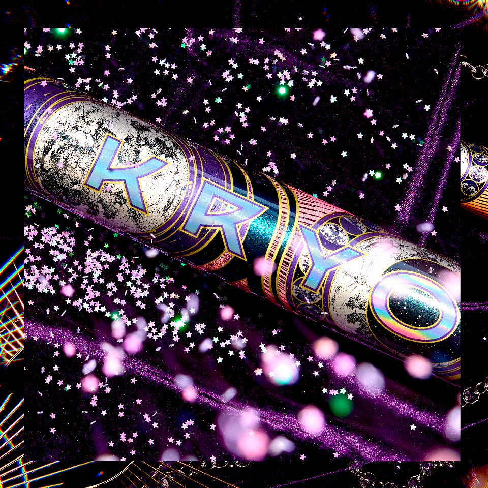 The 2027 Louisville Slugger Kryo2 Empress Fastpitch Softball Bat rests on purple velvet, surrounded by sparkling star confetti and glowing lights.