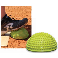 A yellow, dome-shaped Markwort Softball Excellence Power Pod 199PP with a textured, spiked surface, shown both on its own and being stepped on by an athlete wearing a softball cleat to improve lower body strength.