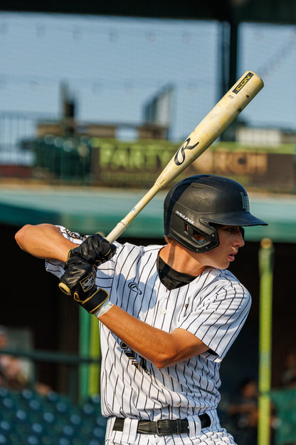 A man holding a 2025 Rawlings Icon (-3) BBCOR Baseball Bat: RB5I3 (DEMO).