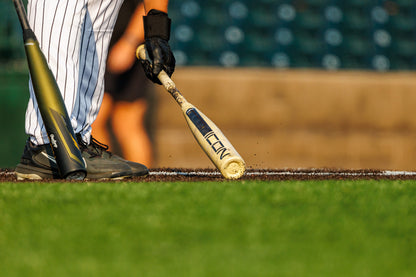 A close-up shows a baseball player in pinstripes at home plate, holding the 2025 Rawlings Icon (-3) BBCOR Baseball Bat: RB5I3 (DEMO), with another bat and blurred figures in the background.