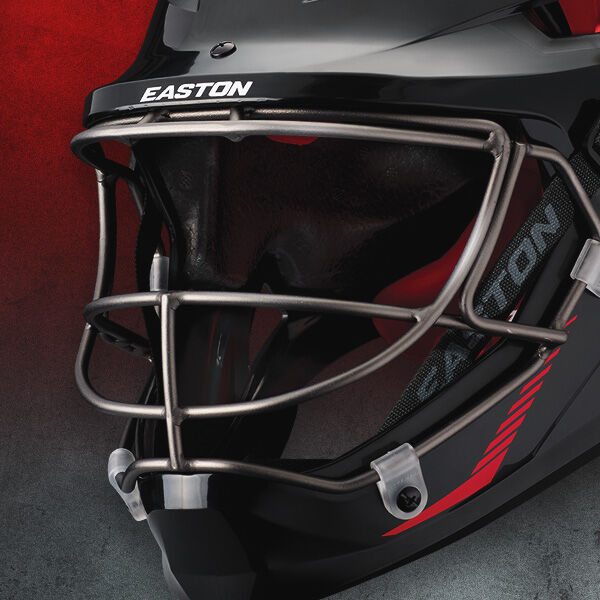 Close-up of a black hockey goalie mask with a metallic face cage, featuring the brand name EASTON above the visor and a red accent design on the side, set against a red and gray gradient background.