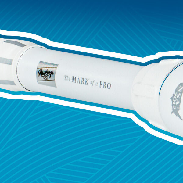 A close-up of a white Rawlings baseball bat with the text The MARK of a PRO printed on it, set against a blue background with a lined pattern.