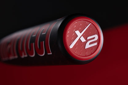 Close-up of the end cap on the 2025 Marucci CATX2 Composite (-8) 2 3/4" USSSA Baseball Bat (DEMO), featuring a striking black, red, and white design with bold X2 text and highlighting its two-piece composite construction.