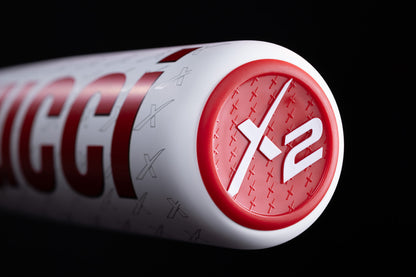 Close-up of the end cap on the Marucci 2025 CATX2 Connect (-10) 2 3/4" USSSA Baseball Bat (MSBCCX210 DEMO), showing a red circular design with white "X2" and a pattern of small X shapes on the cap.