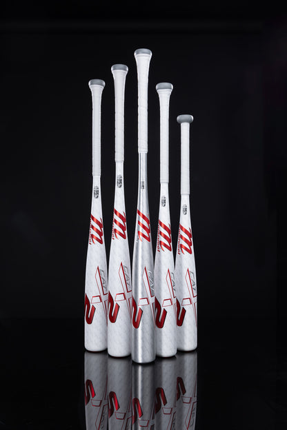 Five Marucci CATX2 (-3) BBCOR baseball bats stand upright in a row, white and silver with red accents, featuring one-piece alloy construction and white grip tape against a black background.