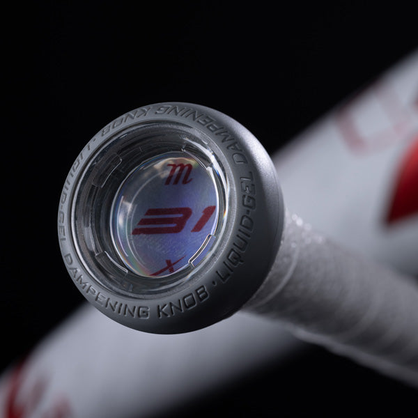 Close-up view of the end cap of a baseball bat with the text Dampening Knob - Liquid-Gel engraved around the edge, featuring a transparent center and white grip, against a dark background.