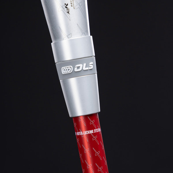 Close-up of a metallic connector labeled OLS attaching a silver tube to a red pole with white text and small patterns, set against a black background.
