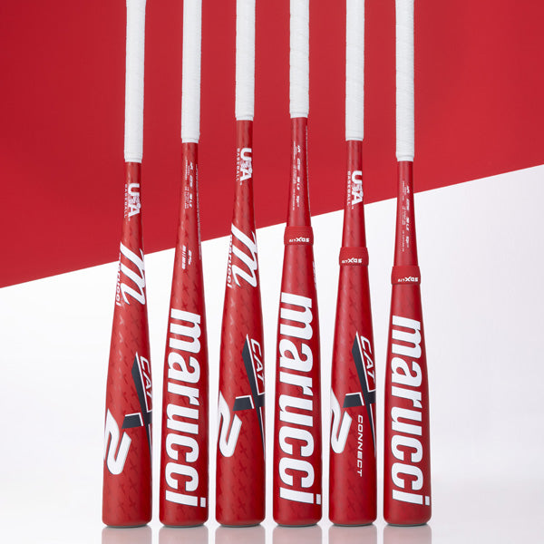 Five red Marucci baseball bats with white grips are standing upright against a red and white background. The Marucci brand name and logo are prominently displayed on each bat.