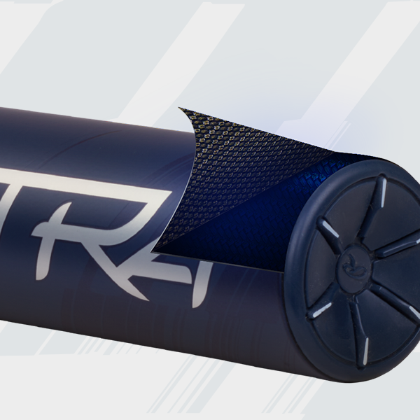 A close-up of a dark blue cylindrical object with a textured outer layer partially peeled back, revealing a different inner surface. The object features bold white lettering and a patterned end cap.