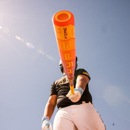 A person holding an Easton 2025 Hype Fire JBB (-10) 2 3/4" USSSA Baseball Bat (EJB5HYP10) featuring advanced Thermo-Composite technology.
