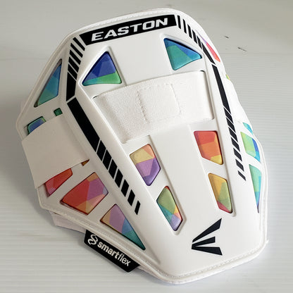 The Easton Compact Batter Elbow Guard: ES37 is a white Easton elbow guard with black accents, vibrant geometric rainbow patterns, and a white adjustable center strap. The SmartFlex logo appears near the bottom edge for added style and protection.