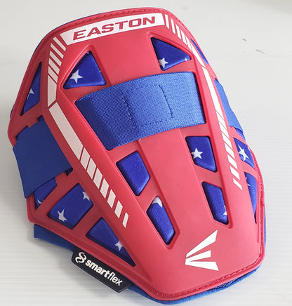 The Easton Compact Batter Elbow Guard: ES37 features red and blue with white stripes and stars, a durable outer shell, adjustable blue strap, and the smartflex logo on a black tag—reliable protection by Easton.