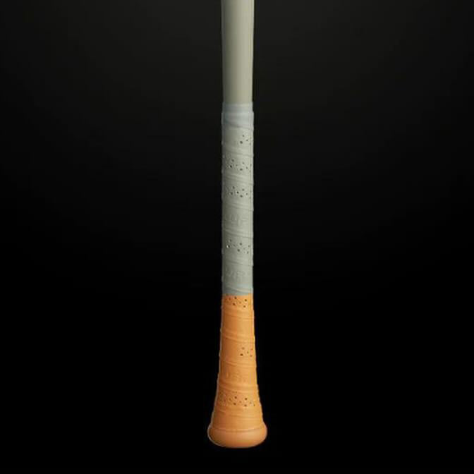 A close-up of the handle of a sports bat, with a textured grip featuring a light gray upper section and an orange lower section, set against a black background.