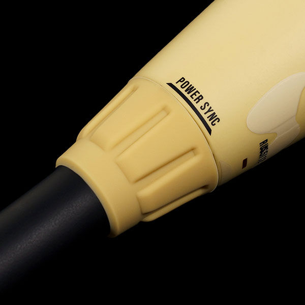 Close-up of a yellow device with the words POWER SYNC printed on it, featuring a textured grip and a black cylindrical shaft against a black background.