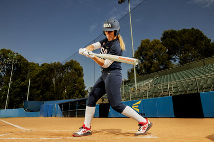 A woman holding a 2025 Easton Ghost Unlimited (-9) Fastpitch Softball Bat (EFP5GHUL9) by Easton.
