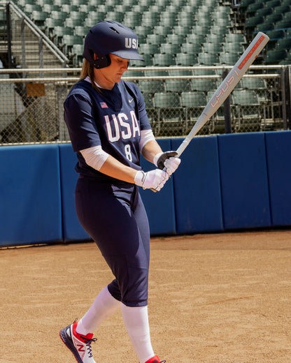 A woman holding the 2025 Easton Ghost Unlimited (-9) Fastpitch Softball Bat (EFP5GHUL9) by Easton.