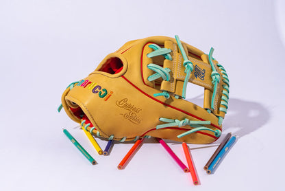 The Marucci NightShift Coloring Book 11.5" Baseball Glove (MFGNTSHFT-0404) features Japanese-tanned steerhide, colorful laces, and embroidered text, shown with scattered colored pencils on a white background.