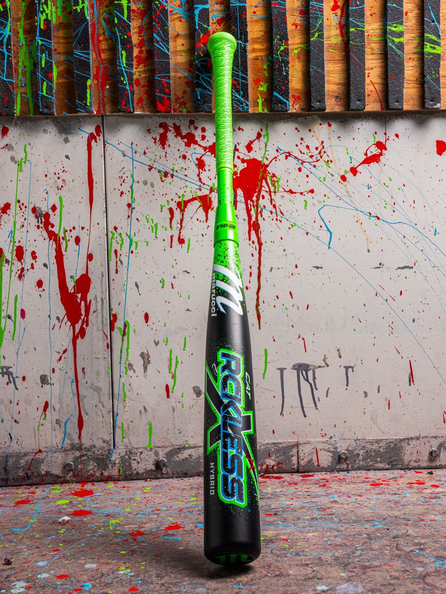 The Marucci CAT X RCKLESS Hybrid (-3) BBCOR Baseball Bat (MCBCRH DEMO) stands upright, its neon green handle and black barrel with bold Reckless graphics showcasing Marucci’s striking design against a paint-splattered wall.