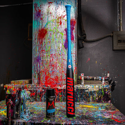 A paint-splattered table features the 2026 Marucci CAT X RCKLESS (-3) BBCOR Baseball Bat (MCBCR) and spray paint.