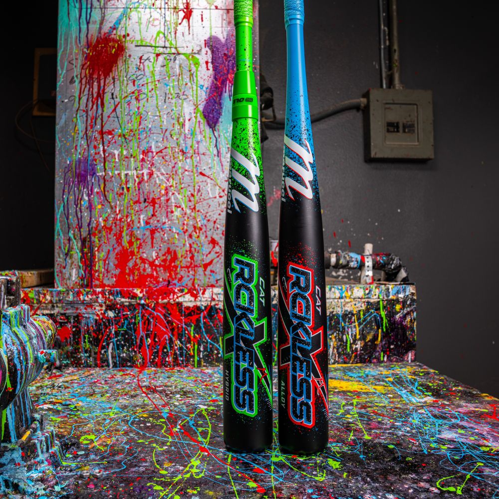 Two colorful baseball bats stand on a paint-splattered surface, their “RECKLESS” design matching the vibrant 2026 Marucci CAT X RCKLESS Hybrid (-3) BBCOR Baseball Bat: MCBCRH (DEMO) by Marucci.