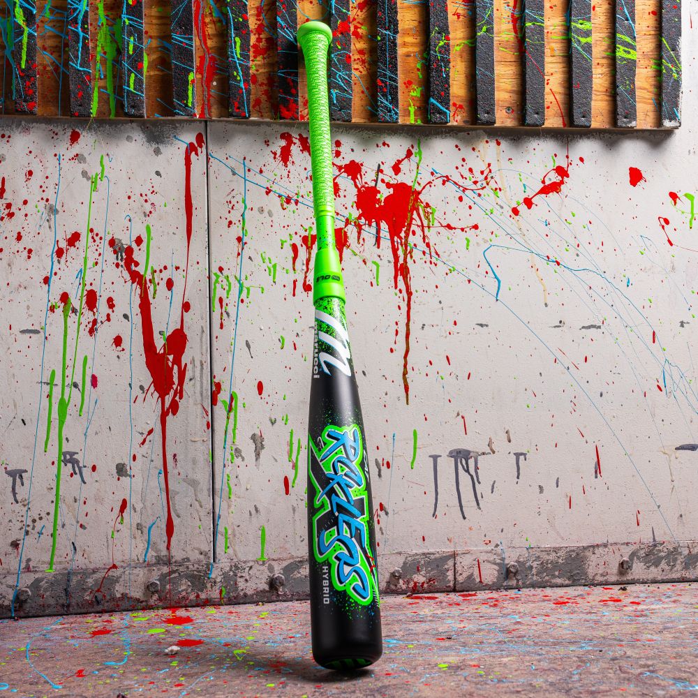 The 2026 Marucci CAT X RCKLESS Hybrid (-5) 2 3/4" USSSA Baseball Bat stands upright, featuring a neon green grip and graffiti-style lettering, with vibrant red, green, and blue paint splatters in the background.