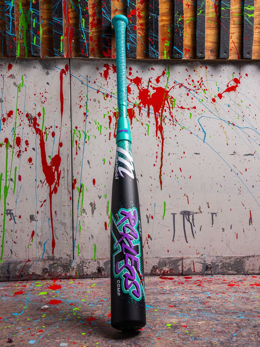 A 2026 Marucci CAT X RCKLESS Composite (-5) USSSA Baseball Bat (MSBCRC5 DEMO) with vibrant paint splatters on the wall.
