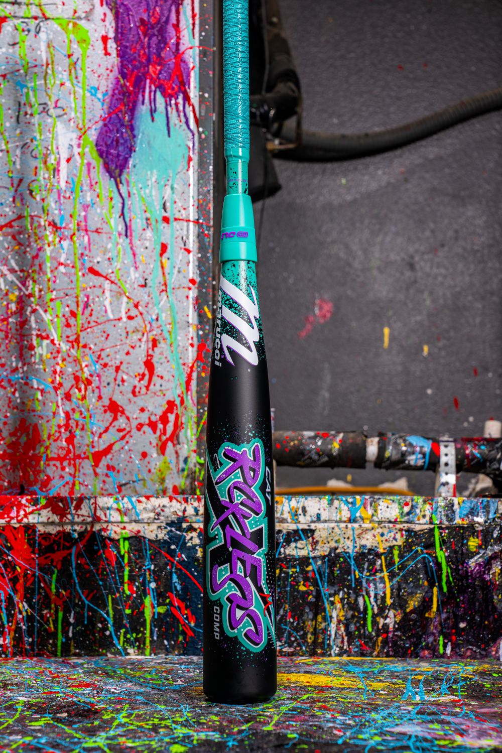 The 2026 Marucci CAT X RCKLESS Composite (-5) 2 3/4" USSSA Baseball Bat features a striking paint-splatter design on its composite barrel, delivering bold style and top performance.