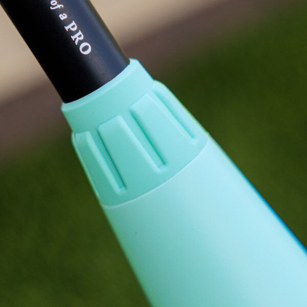 Close-up of a turquoise handle with vertical grooves, attached to a black rod with partial white text, against a blurred green and beige background.