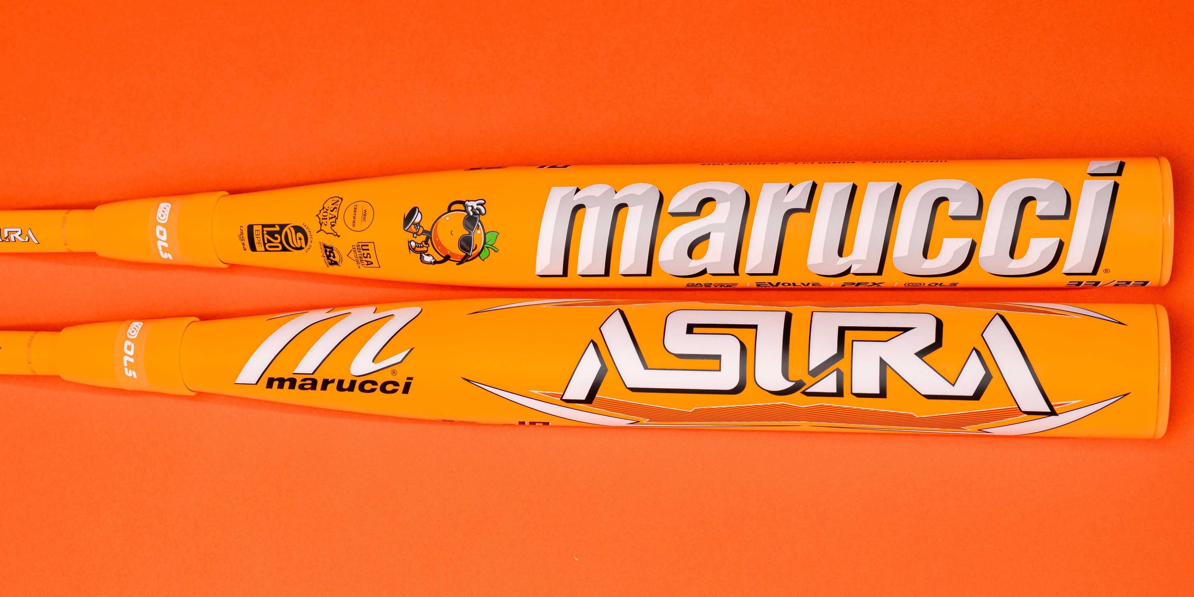 Two orange Marucci baseball bats with white and black branding, lying side by side on an orange background. The top bat displays marucci in large letters, and the bottom bat shows the ASURA model name.