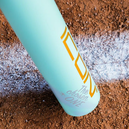 A 2026 Rawlings ICON CHOSEN ONE (-10) USA Baseball Bat rests on dirt by a chalk baseline, its light blue barrel displaying "The Chosen ONE" in yellow and white text.