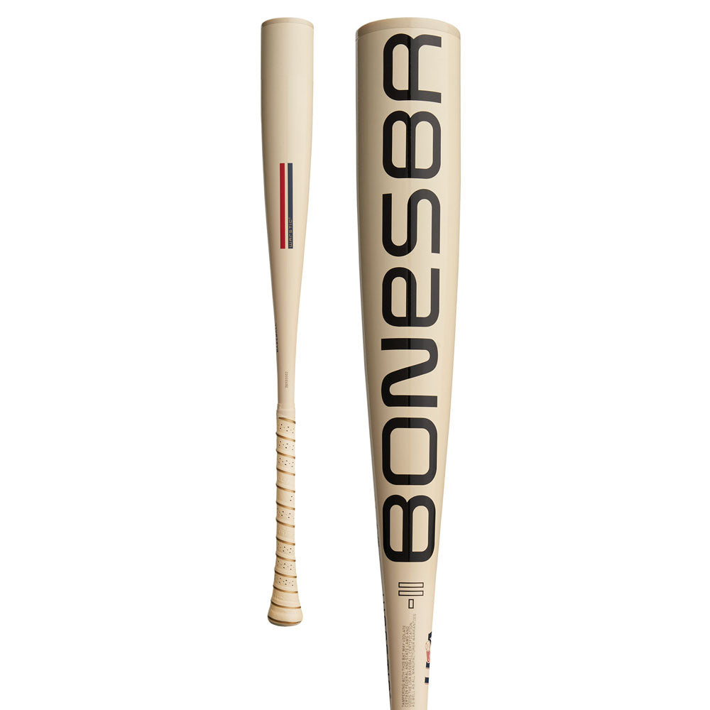 The 2025 Warstic Bonesaber (-11) USA Baseball Bat features a cream Katana1X Alloy Barrel with bold black BONESBR branding and a wrapped grip. Shown in front and side views, it highlights an ultra light swing speed.