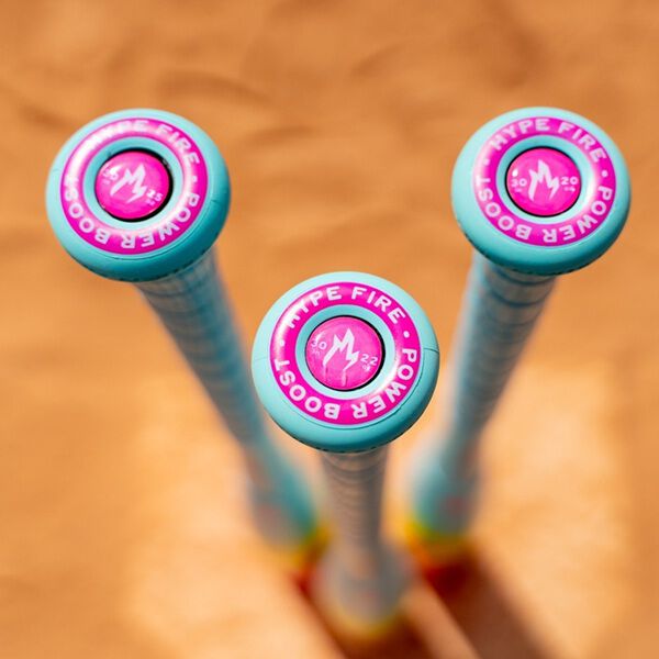 Three vibrant 2026 Easton Hype Fire (-5) USSSA Baseball Bats with turquoise handles and pink-purple endcaps stand upright on sand, displaying the HYPE FIRE POWER BOOST logo and showcasing ThermoComposite tech, viewed from above.