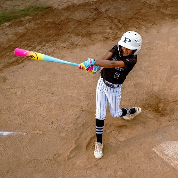 A young player in a black and white uniform swings the 2026 Easton Hype Fire (-5) USSSA Baseball Bat at home plate, its advanced design delivering power and precision, while he wears a white helmet and striped pants on the dirt field.