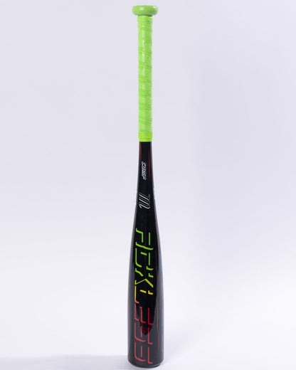 Standing upright against a plain white background is the Marucci 2027 RCKLESS Gen 2 Composite (-13) 2 5/8″ USA Tee Ball Baseball Bat (MTBRC2), a black, USA Baseball certified bat featuring a bright neon green grip and vibrant geometric patterns decorating the barrel.