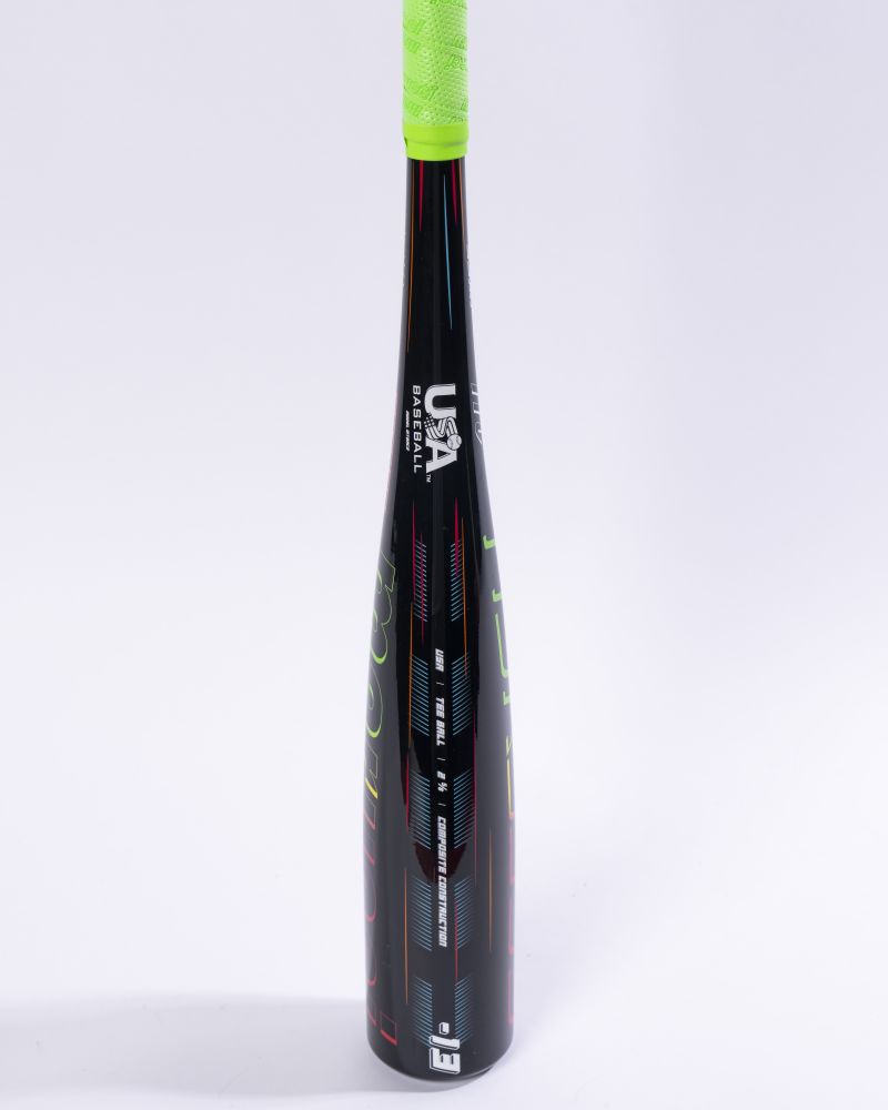 The Marucci 2027 RCKLESS Gen 2 Composite (-13) 2 5/8″ USA Tee Ball Baseball Bat (MTBRC2), featuring a black barrel, neon green grip, and vibrant red and blue accents along with the USA Baseball certified logo, stands upright against a plain white background.