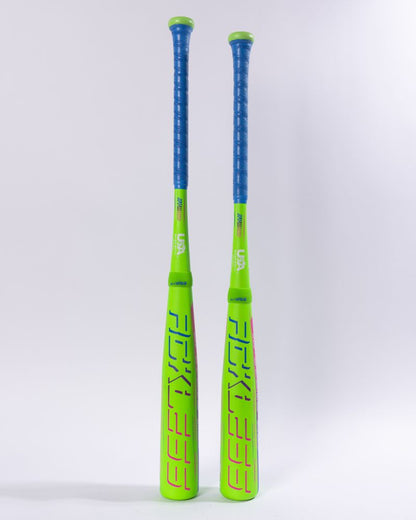 Two neon green Marucci RCKLESS Gen 2 Hybrid (-8) baseball bats with blue grips stand upright side by side against a plain white background. Featuring Ring-Free Barrel Construction, these Marucci bats display bold graphics and branding—highlighted in vibrant pink and black text—along their barrels.