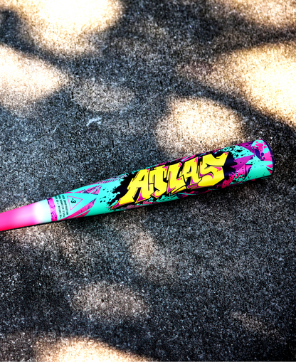 The 2026 Louisville Slugger Atlas Wildstyle (-3) BBCOR Baseball Bat (WBL4178010) features bold yellow graffiti-style text and vibrant pink, teal, black, and purple designs, making it a colorful 1-piece alloy bat from Louisville Slugger.