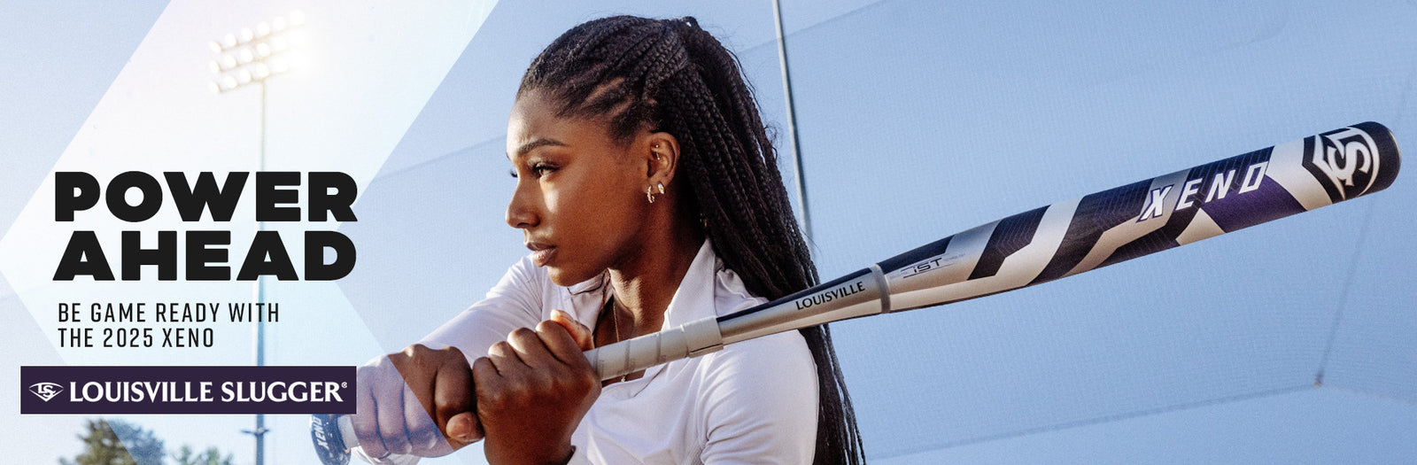 A focused female softball player holding a Louisville Slugger Xeno bat prepares to swing, with the text Power Ahead. Be game ready with the 2025 Xeno. Louisville Slugger in the background.
