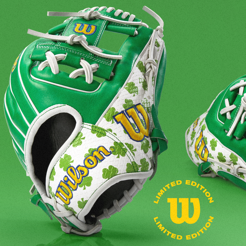 A green and white Wilson baseball glove with yellow accents and cloverleaf patterns, shown against a green background. A yellow LIMITED EDITION Wilson logo appears in the bottom right corner.