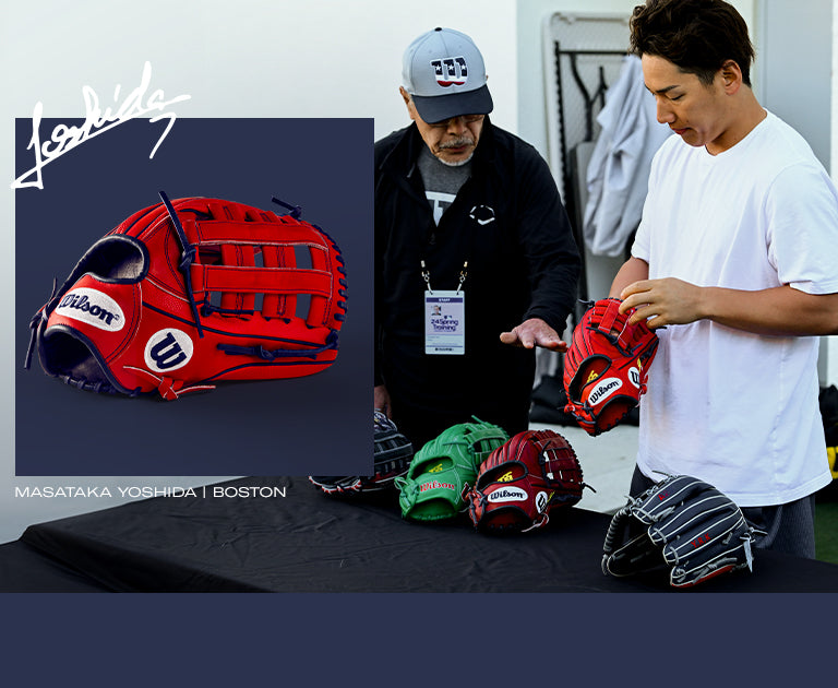 A man admires a Wilson A2000 MY7 12.5" Masataka Yoshida GM Baseball Glove (WBW102529125), inspecting its details with interest.