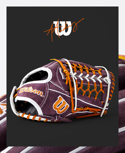 The Wilson A2000 T125 12.5" Aliyah Andrews GM Fastpitch Glove (WBW102745125) by Wilson features a maroon design with orange and white laces, stylized orange A and W lettering, and the Wilson logo, inspired by Aliyah Andrews.