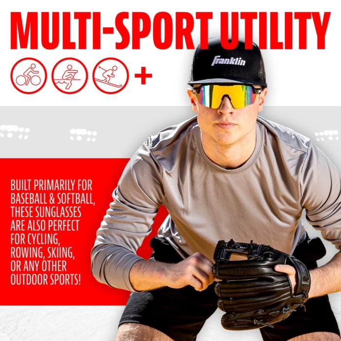 A man in a gray shirt, black shorts, and a Franklin cap wears Franklin MLB Pro Sunglasses: 24012C with UV protection—ideal for baseball, softball, cycling, and rowing—and holds a glove.