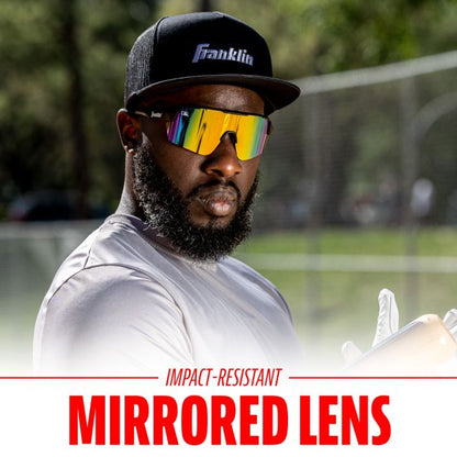 A bearded man in a black cap, white shirt, and Franklin MLB Pro Sunglasses: 24012C stands outdoors holding a baseball glove. The text below reads: Impact-Resistant Mirrored Lens by Franklin.