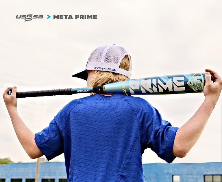 A child in a blue shirt and white cap holds a Louisville Slugger Meta Prime (-8) 2 3/4" USSSA Baseball Bat (WBL2971010 DEMO) across their shoulders, with USSSA and Meta Prime logos visible in the upper left corner.