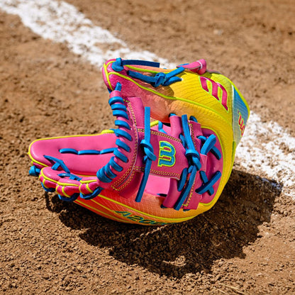 A Wilson A2000 1786SS 11.5" Baseball Glove with pink and yellow SuperSkin rests on the dirt. Model: WBW103492115.