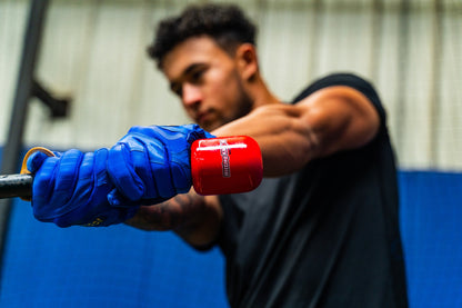 A man wearing boxing gloves shows how proper bat speed matters, similar to training with the Hitting Knob Bat Weight by Hitting Knob—a quality baseball hitting aid.