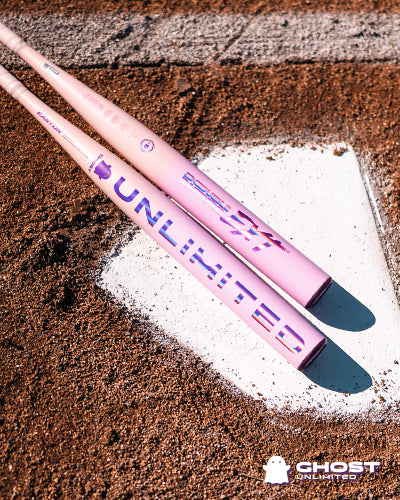 Two pink and purple 2026 Easton Ghost Unlimited (-10) Fastpitch Softball Bats (EFP6GHUL10) with "UNLIMITED" printed on them lie crossed on home plate. Double Barrel EXT and GHOST UNLIMITED logos appear at the lower right.