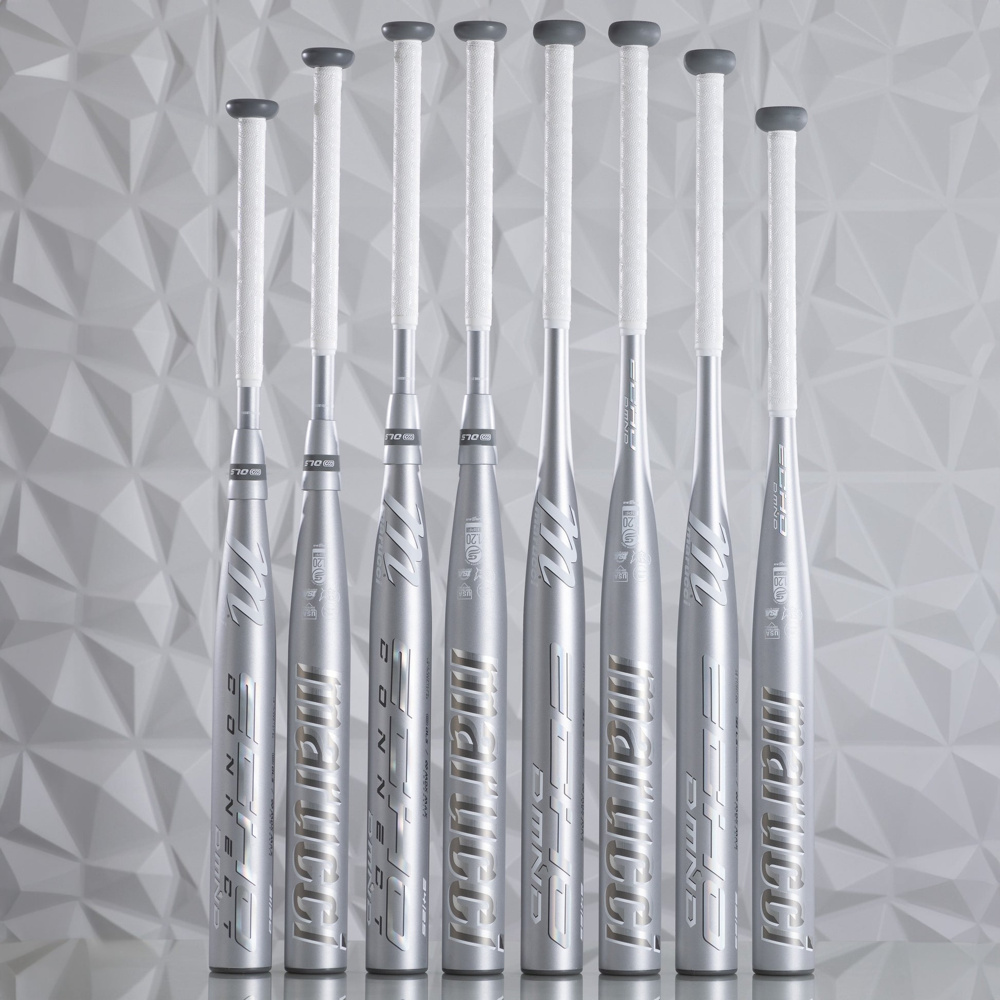 Eight silver fastpitch softball bats with white grips, including the 2025 Marucci Echo DMND2 (-11) MFPED211, stand upright in a row against a light geometric patterned background, highlighting their sleek, modern design.
