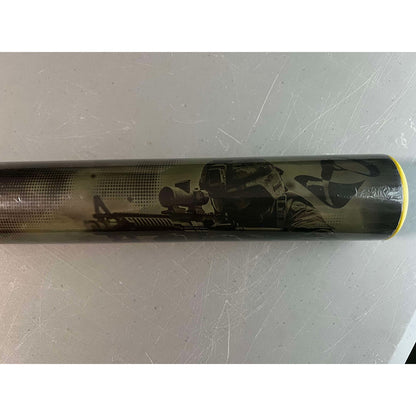 The Pure Sports 2025 Hellfire X22 13″ Endload USA Softball Bat (5135M565) features a soldier in tactical gear aiming a rifle on a gray background, with a distinctive yellow rim at the end.