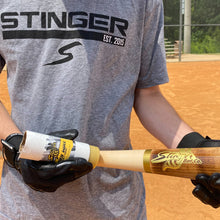 A person holding a baseball bat with a Stinger Sports Stinger BEES WAX Bat Grip: BEESWAX.